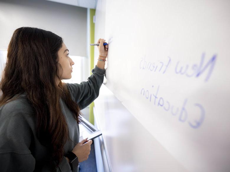 Student writing on white board at Penn State Abington (near Philadelphia)